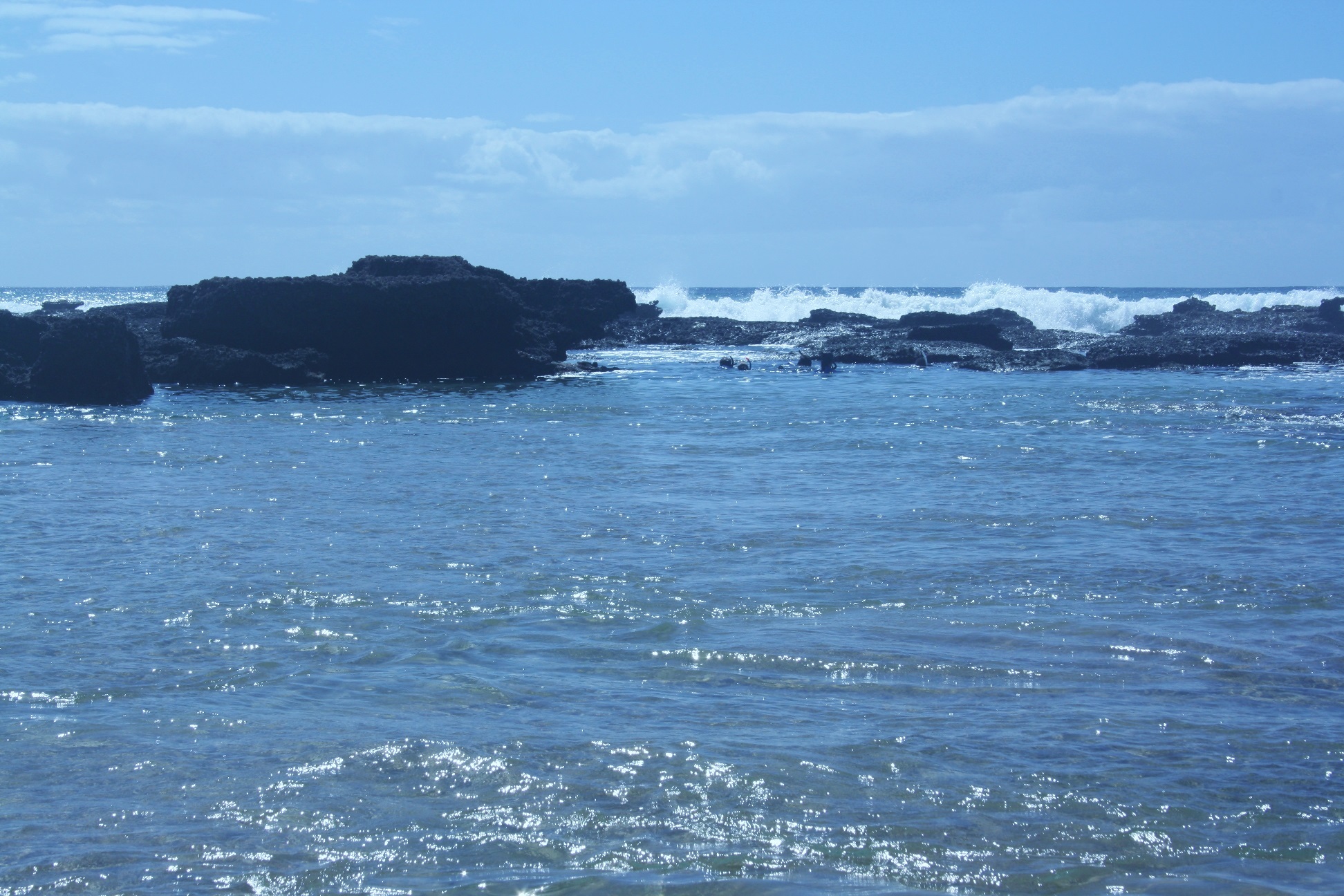 A family snorkeling in a safe rock pool.